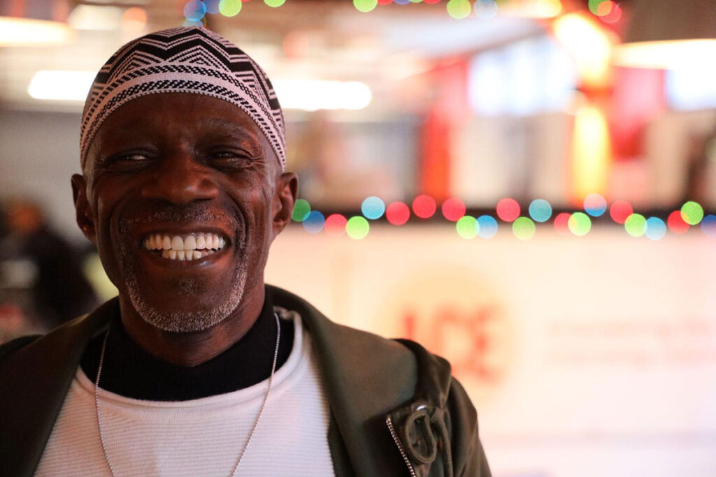 Smiling African American man in front of blurred ACE Hardware store
